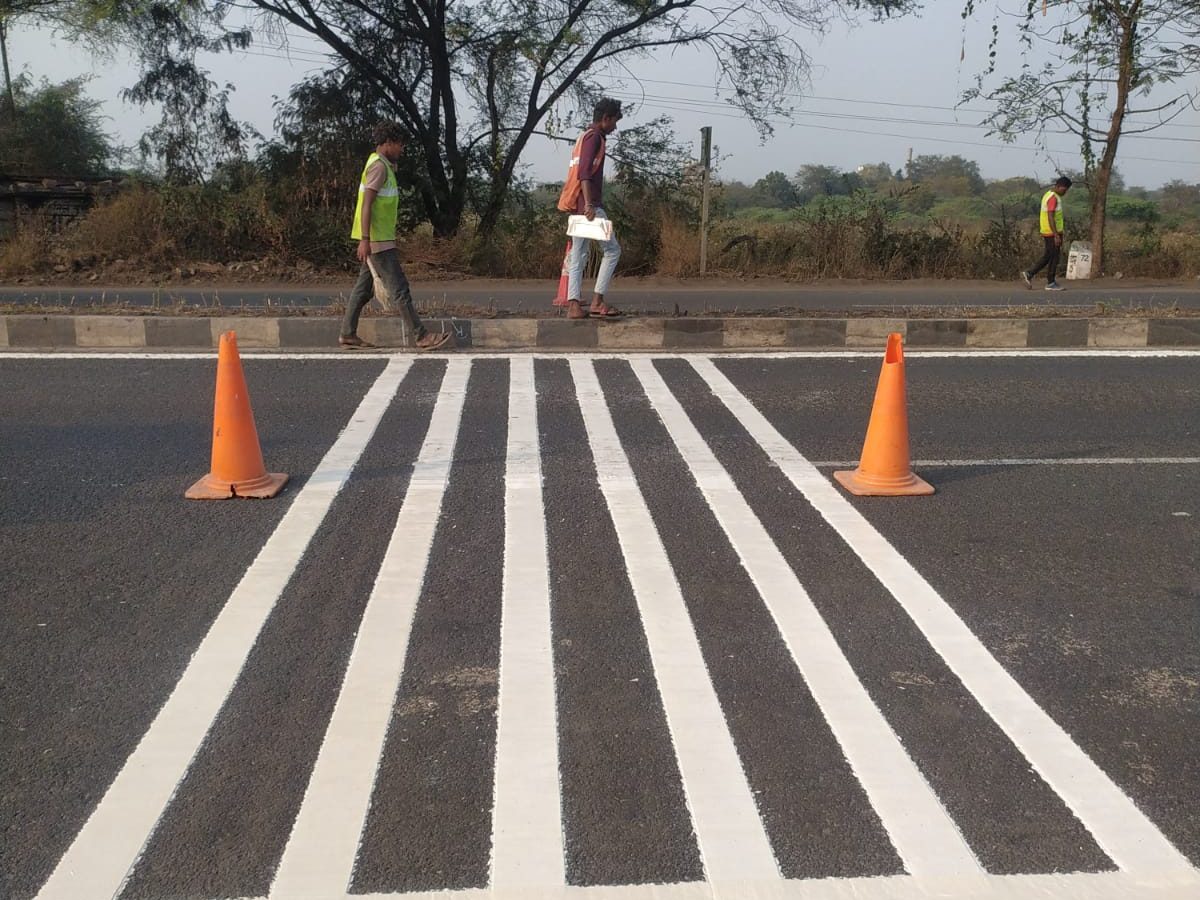 A newly painted pedestrian crossing between two traffic cones at Anturla